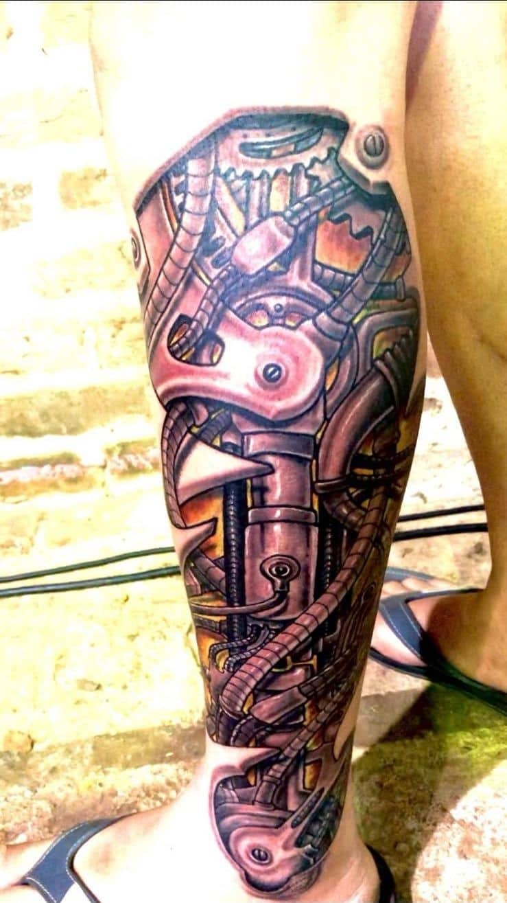 Tattoo by Ricardo Mendes, biomechanical piece in colour on a calf