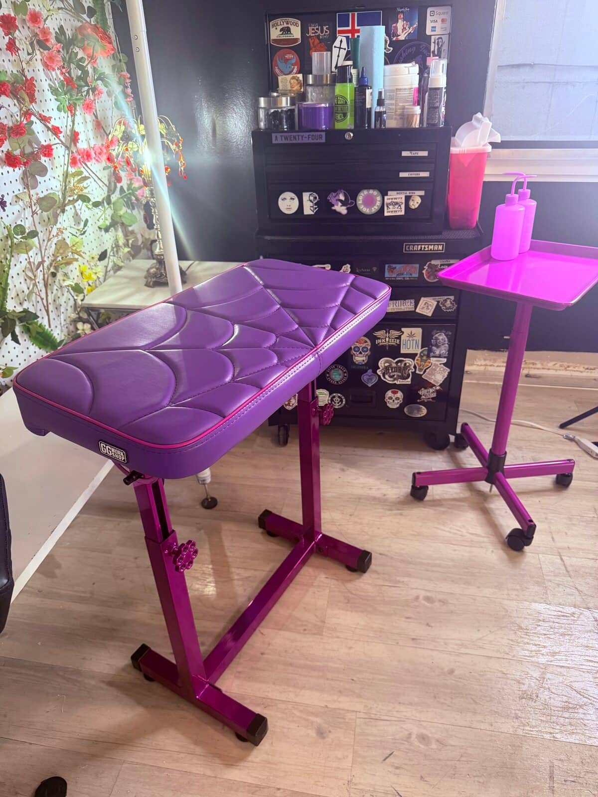 The purple armrest and the magenta instrument cart set up beside the chair