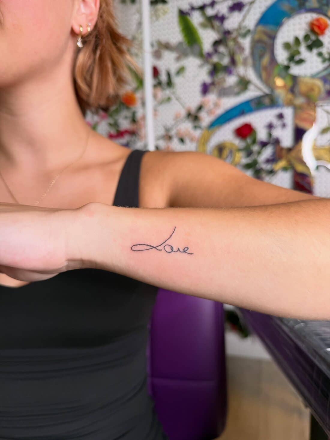 Tattoo by Apollonia Ink in Barrie, the word Love in handwriting script on a forearm