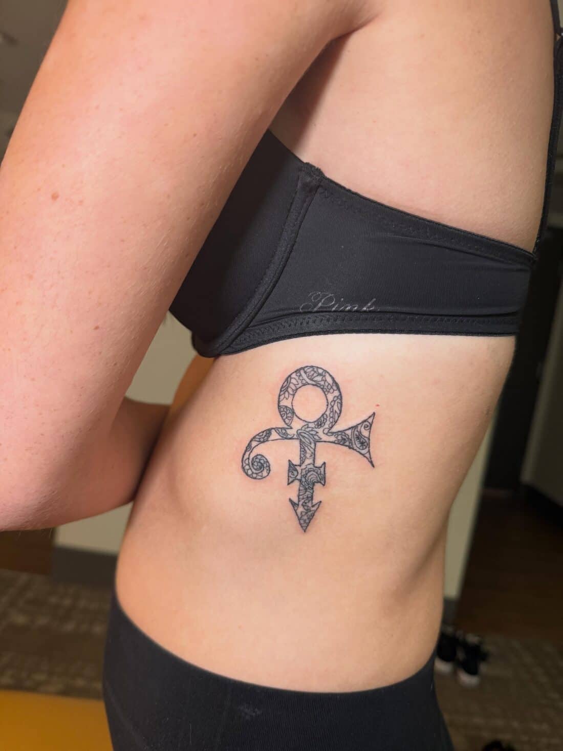Tattoo by Apollonia Ink in Barrie, Prince love symbol along the ribs