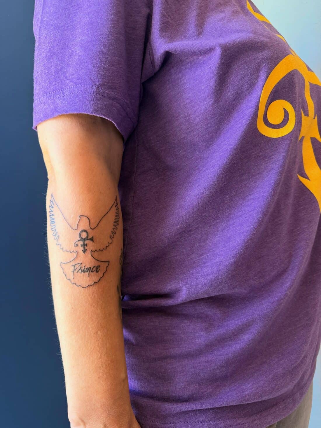 Tattoo by Apollonia Ink in Barrie, fine line dove carrying the Prince love symbol